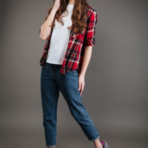 Trendy girl in plaid shirt